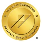 The Joint Commission National Quality Approval seal, a gold circle with four triangles inside