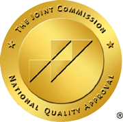 The Joint Commission National Quality Approval seal, a gold circle with four triangles inside