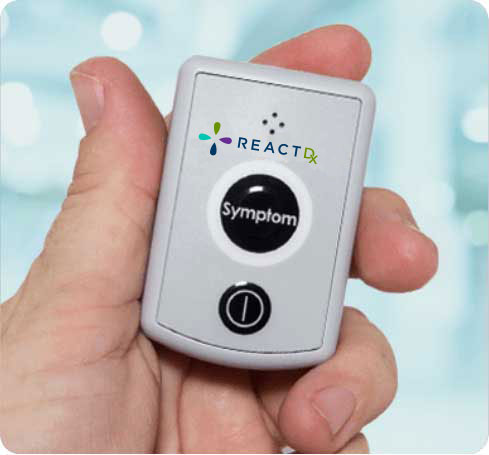 Hand-Holding-a-Cardiac-Monitor-with-ReactDx-Logo